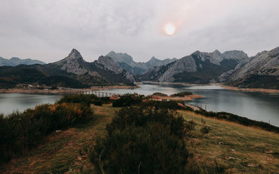 Scenic view of lake and mountains against sky