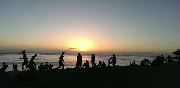 People on beach at sunset