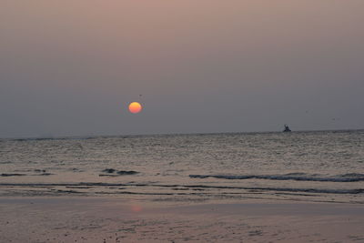 Scenic view of sea against clear sky during sunset