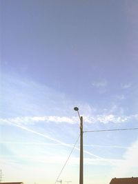 Low angle view of power lines against blue sky