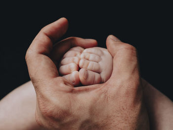 Cropped image of couple holding hands