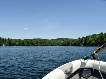 Boat sailing on river against sky