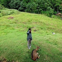 Girl standing on grassy field in park