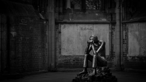 Woman sitting in abandoned building