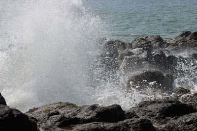 Waves splashing rocks at sea