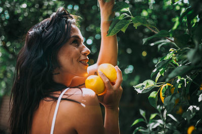 Young woman looking away on tree