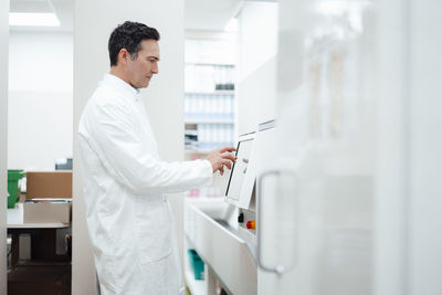 Pharmacist using monitor screen in pharmacy