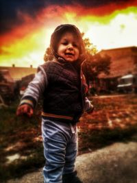 Smiling girl wearing multi colored against sky during sunset