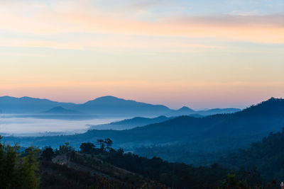 Scenic view of mountains against sky at sunset