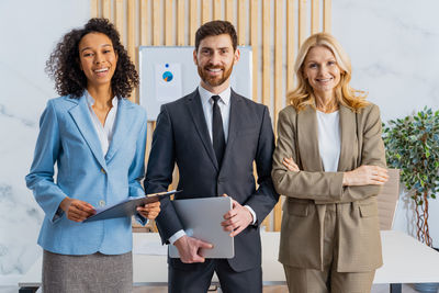 Portrait of business colleagues standing in office