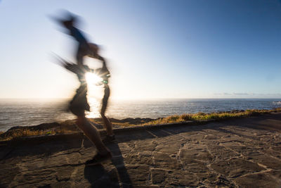 Man standing on beach against clear sky