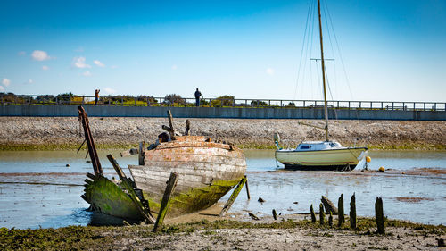 Boats moored in sea against clear sky