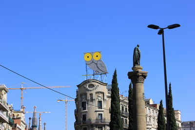 Low angle view of buildings against clear blue sky