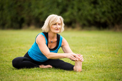 Young woman sitting on grass