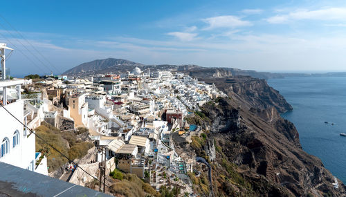 High angle view of townscape by sea against sky