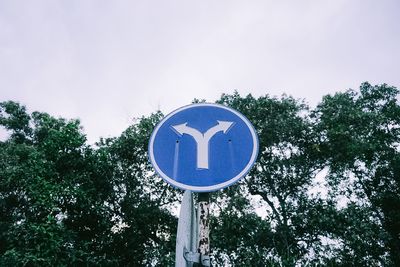 Low angle view of road sign against sky