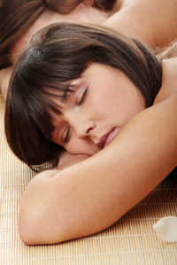 Close-up portrait of a young woman lying