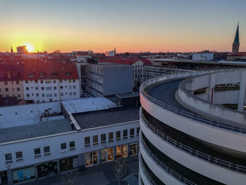 High angle view of buildings in city at sunset