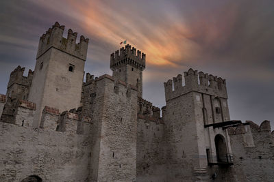 Low angle view of old ruins against sky during sunset