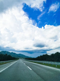 Empty road along countryside landscape