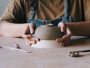 Midsection of man working on table