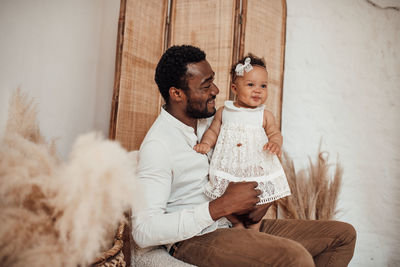 Happy friends sitting outdoors