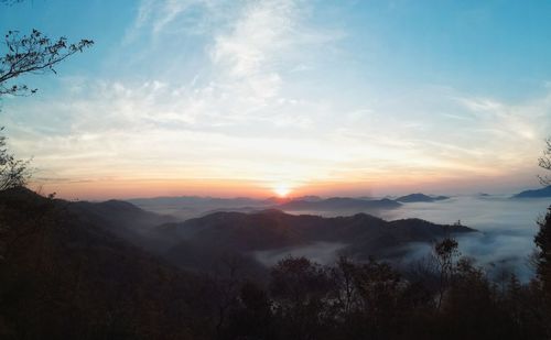 Scenic view of silhouette mountains against sky during sunset