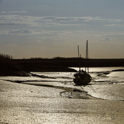 Sailboats in sea against sky