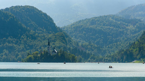 Scenic view of sea and mountains against sky