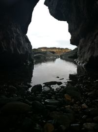 Scenic view of sea seen through cave