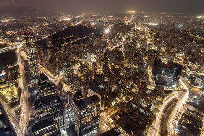 High angle view of illuminated buildings in city at night