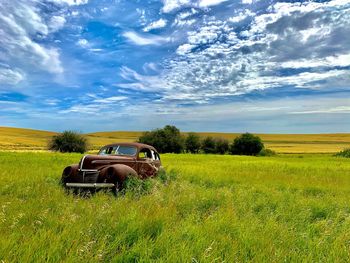 Tractor on field against sky