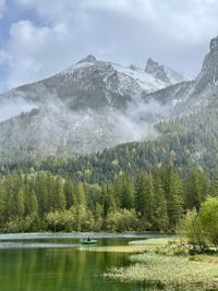 Scenic view of lake and mountains against sky