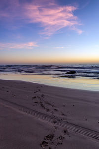 Scenic view of beach against sky during sunset