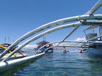 Sailboats in sea against clear blue sky