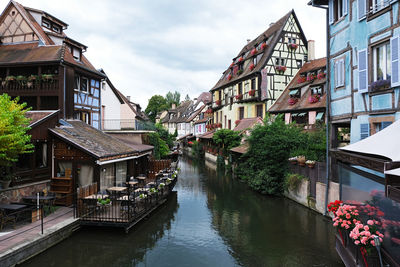 Canal amidst buildings against sky