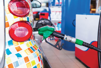 Filling petrol fuel in car at gas station