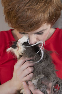 Close-up of woman kissing guinea pig