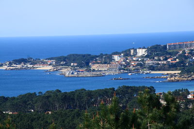 High angle view of town by sea against sky