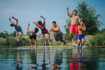 People enjoying in water against sky