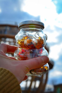 Close-up of person holding glass jar