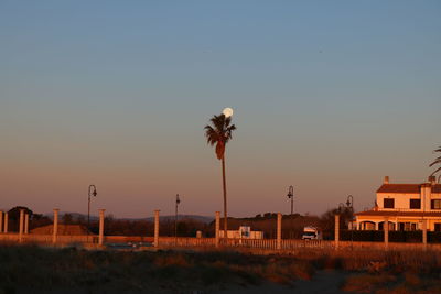 Scenic view of building against clear sky during sunset