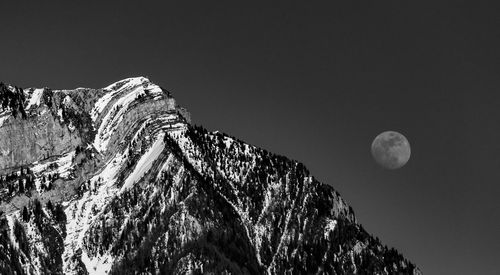 Low angle view of rock formation against sky at night