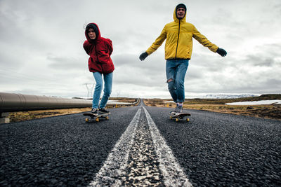 Full length of man standing on road against sky