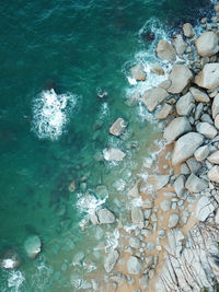 High angle view of rocks in sea