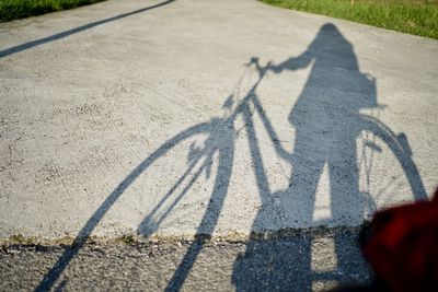 High angle view of shadow of bicycle on street