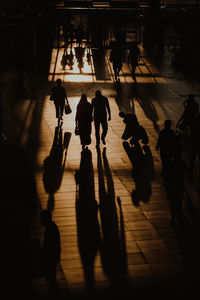 High angle view of silhouette people walking in city