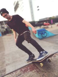 Man skateboarding on skateboard in city