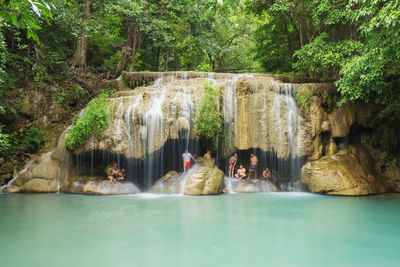 People at waterfall in forest