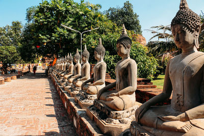 Statues in temple against trees